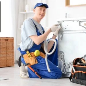 “Technician repairing a washing machine with tools and equipment in a home setting.”