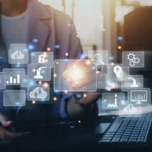 Professional working on a laptop with glowing digital icons representing marketing, data, and technology, symbolising advanced digital marketing strategies.