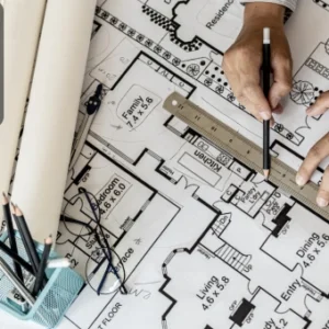 Architect measuring floor plan with ruler on AutoCAD blueprint, integrating design data with Excel.