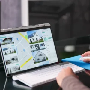 A person browsing property listings and a map on a laptop screen, illustrating online property marketing.