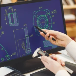 Engineer programming AutoCAD design automation using C# with Windows Forms on a computer screen.