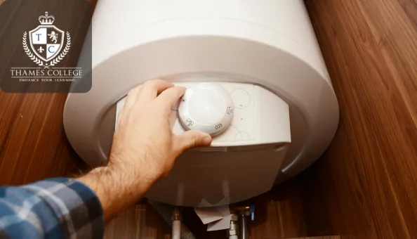 A person adjusts the temperature control on a household boiler mounted inside a wooden cabinet. The Thames College logo appears in the top-left corner.