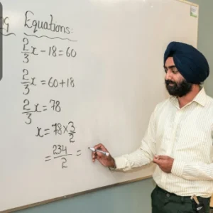 A teacher solving algebraic equations on a whiteboard while explaining to students.