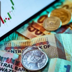 Close-up of global currencies, coins, and a trading chart on a digital screen, symbolising forex, investment, and cryptocurrency strategies.