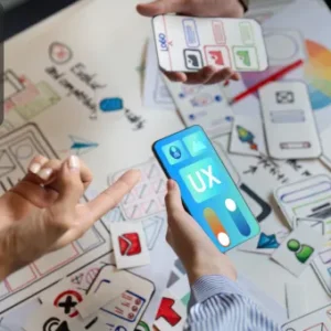 Designers collaborating on creating user interfaces (UI) and user experience (UX) for a mobile game, showcasing prototypes and sketches.