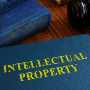 A book titled Intellectual Property and a gavel, signifying the importance of Conveyancing & Property Law and legal procedures in property transactions.