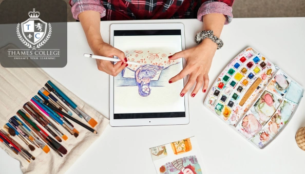 Artist using a digital tablet to create an illustration, surrounded by brushes and watercolours, symbolising the blend of traditional and digital design skills.