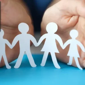 Two hands holding paper cut-out figures of a family, symbolising the importance of protection in security services.