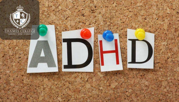 The letters “ADHD” pinned on a corkboard with colourful pushpins, representing Attention Deficit Hyperactivity Disorder.