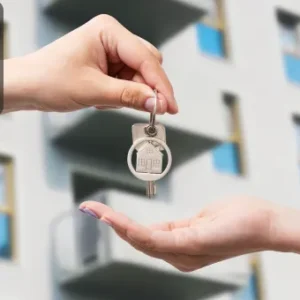 One hand passes a set of keys with a house-shaped keychain to another hand, with a modern apartment building in the background. The Thames College logo is shown in the top left corner.