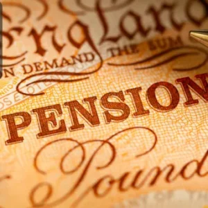 Close-up of the word “PENSION” printed on a UK banknote with a gold pen and coin, representing retirement savings and financial planning in the UK.