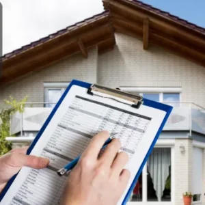 Person holding a clipboard and pen, completing a property inspection checklist outside a modern residential house.
