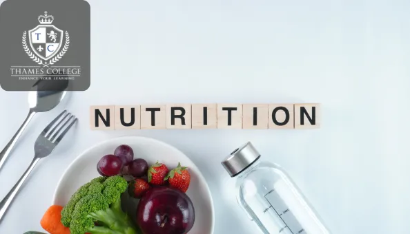 Bowl of fresh fruits and vegetables alongside a water bottle, with wooden blocks spelling out "NUTRITION," symbolising superfoods for health and fitness.