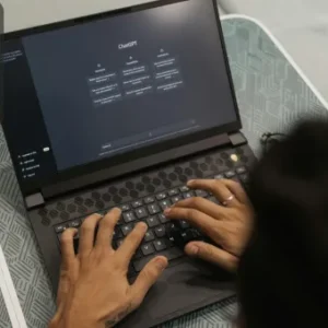 Person typing on a laptop with ChatGPT open on the screen, indicating the use of AI for marketing and productivity tasks.