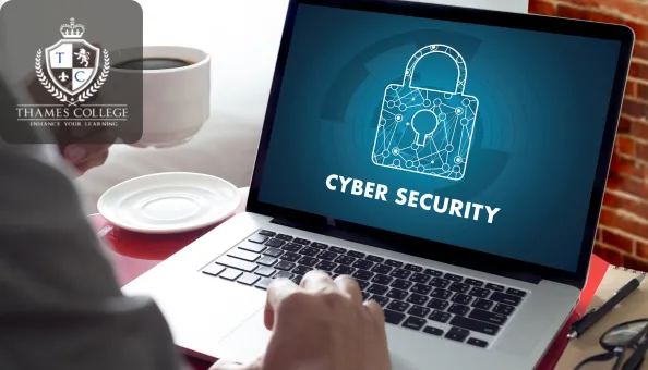 Laptop screen displaying a digital padlock icon with the words “Cyber Security,” held by a professional at a desk with a coffee cup—symbolising online protection and data defence.