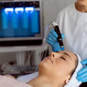 Dermatologist performing a professional skin treatment on a female patient using specialised equipment.