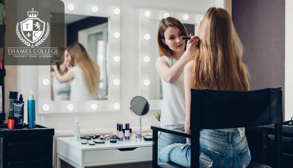 Makeup artist applying cosmetic products to a client in a professional studio setting.